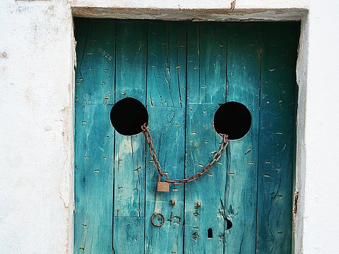 An old door with an rusty lock on it