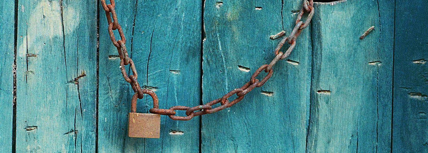 An old door with an rusty lock on it